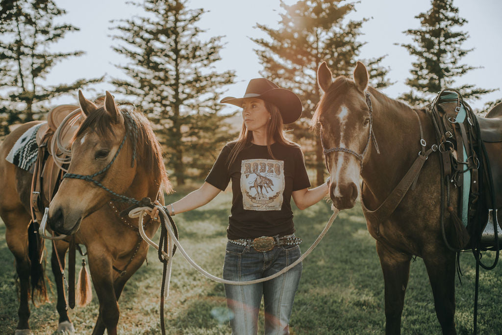 Cowgirl with two horses wearing Vintage Rodeo Tee