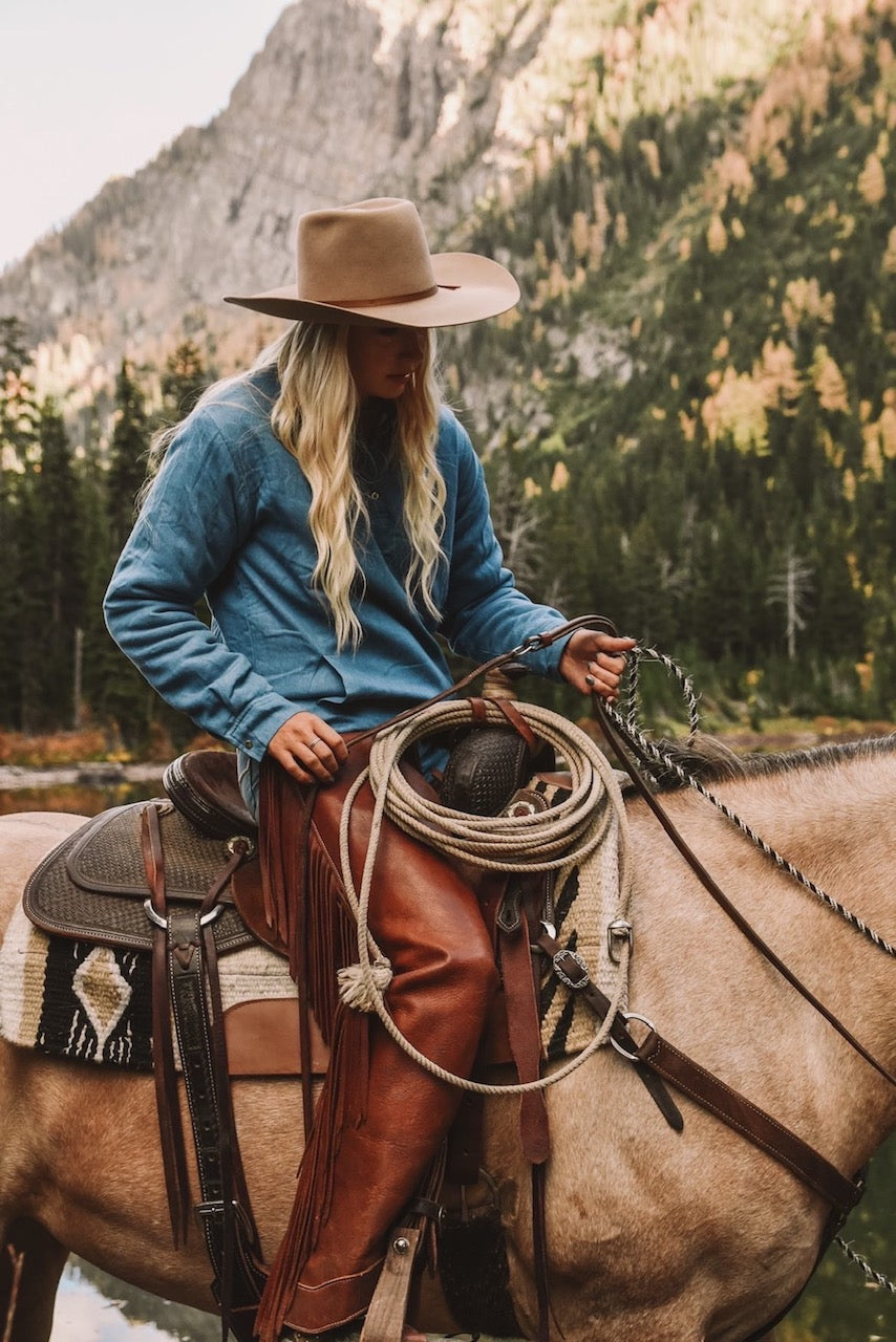 cowgirl on horse wearing sherpa pullover